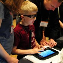 a boy exploring a accessible device.